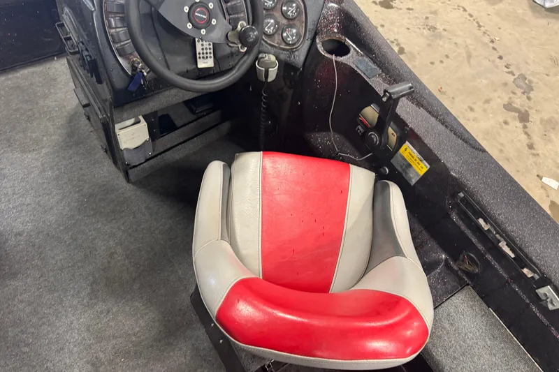 Slide: The Image of Interior of a 2002 Tracker Targa 2000 boat with red and gray seating. - 5