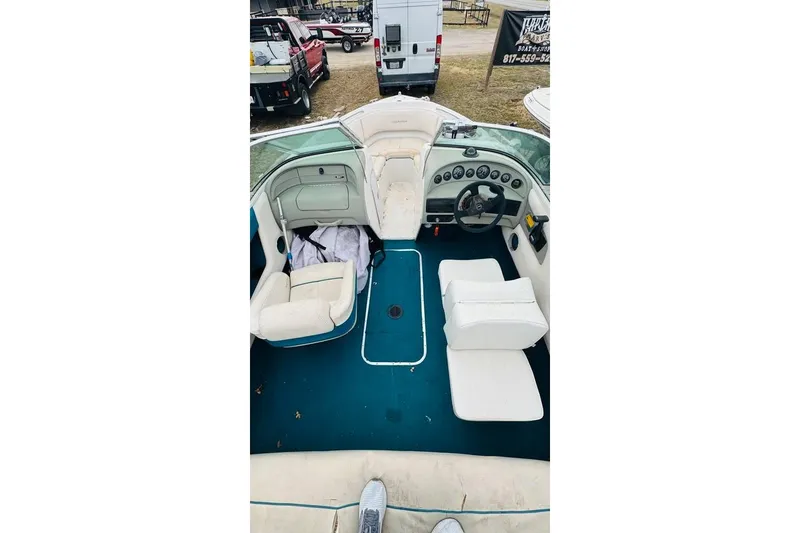 Slide: The Image of Interior view of a 1994 Chaparral 1930 SS boat with white seating and blue carpet. - 11