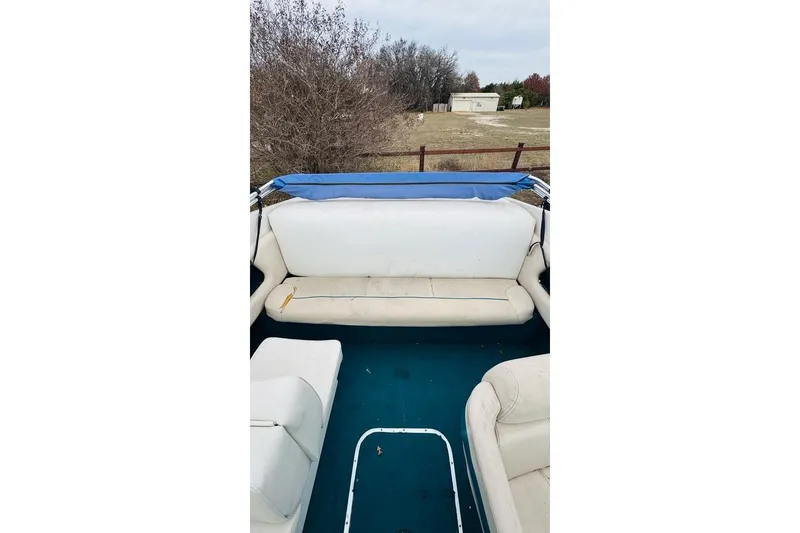 Slide: The Image of 1994 Chaparral 1930 SS boat interior with white seating and blue flooring. - 14