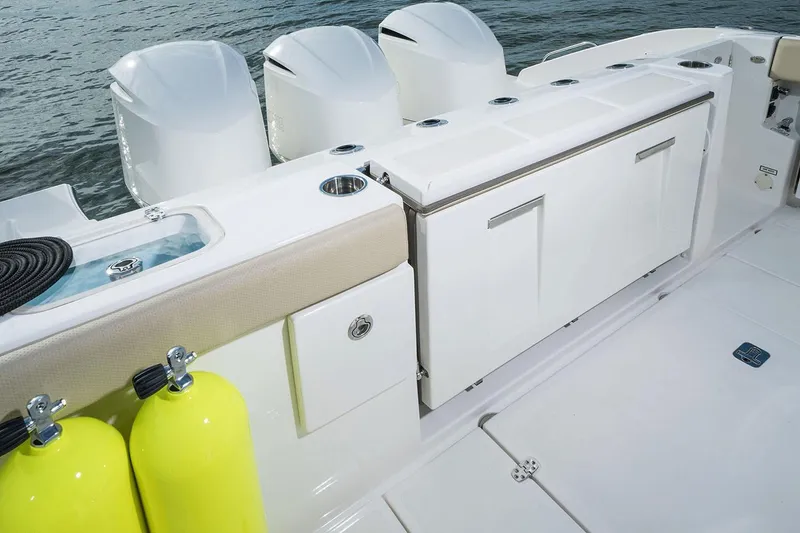 Slide: The Image of Manufacturer Provided Image: 2021 Pursuit DC 365 Dual Console boat with triple outboard engines and storage compartments. - 20
