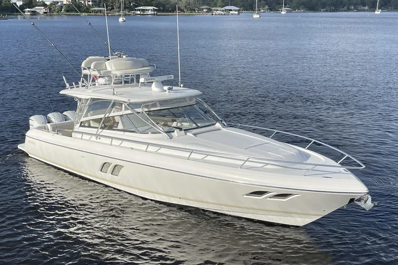 Slide: The Image of 2009 Intrepid 430 Sport Yacht on calm water, showcasing sleek design and luxury features. - 1