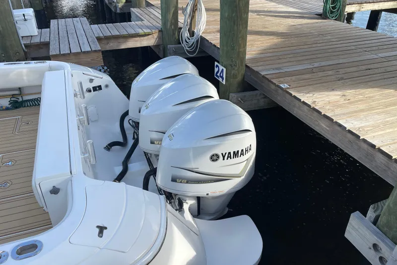 Slide: The Image of Triple Yamaha V8 engines on a 2009 Intrepid 430 Sport Yacht docked at a marina. - 11