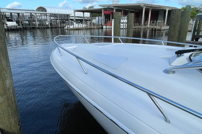 Slide: The Image of 2009 Intrepid 430 Sport Yacht docked at marina, showcasing sleek design and polished railings. - 12