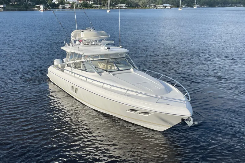 Slide: The Image of 2009 Intrepid 430 Sport Yacht on calm waters, showcasing sleek design and luxury features. - 2