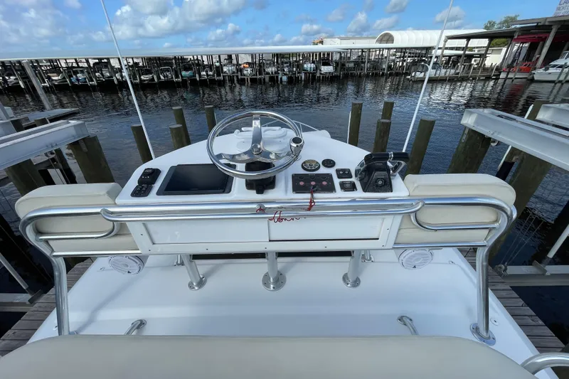 Slide: The Image of Helm of 2009 Intrepid 430 Sport Yacht at marina, featuring steering wheel and controls. - 22