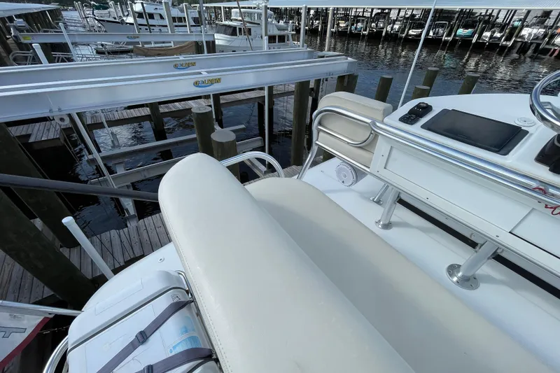Slide: The Image of 2009 Intrepid 430 Sport Yacht helm with seating, docked at marina. - 23
