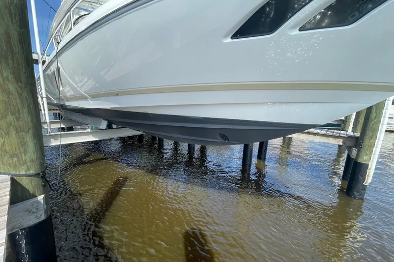 Slide: The Image of 2009 Intrepid 430 Sport Yacht on lift, showcasing sleek hull design. - 26