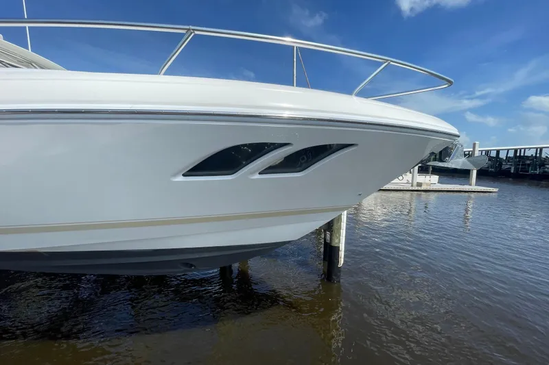 Slide: The Image of 2009 Intrepid 430 Sport Yacht bow view at marina, clear sky background. - 27