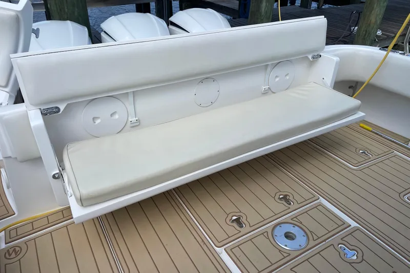 Slide: The Image of 2009 Intrepid 430 Sport Yacht with cushioned bench seat on teak deck. - 29