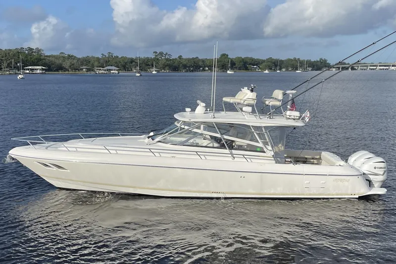 Slide: The Image of 2009 Intrepid 430 Sport Yacht cruising on a calm lake under a cloudy sky. - 3