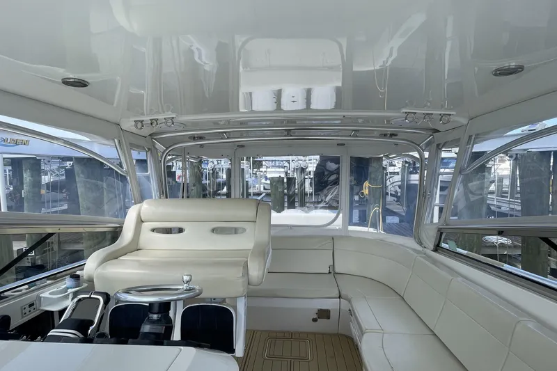 Slide: The Image of Interior of a 2009 Intrepid 430 Sport Yacht with white seating and helm. - 35
