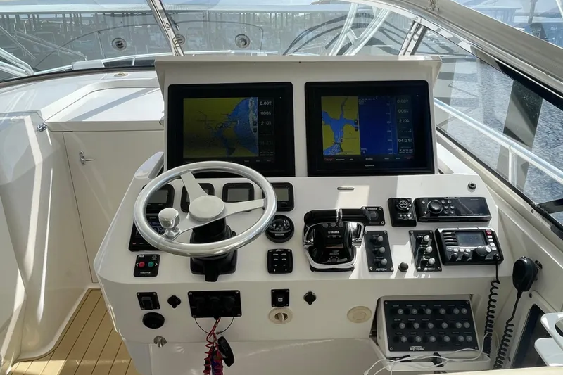 Slide: The Image of Helm of 2009 Intrepid 430 Sport Yacht with dual navigation screens and controls. - 38