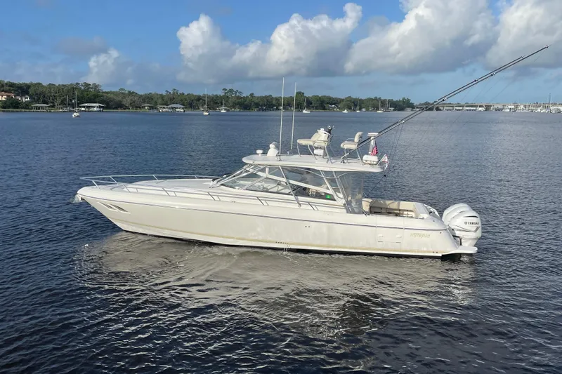 Slide: The Image of 2009 Intrepid 430 Sport Yacht on calm water under a partly cloudy sky. - 4