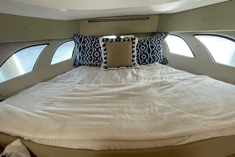 Slide: The Image of Cozy cabin interior of 2009 Intrepid 430 Sport Yacht with plush bedding and decorative pillows. - 42