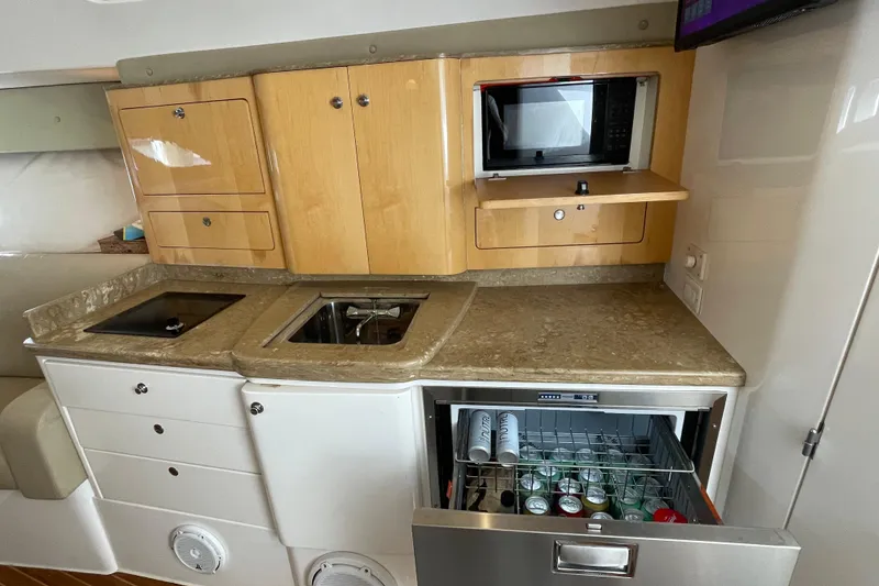 Slide: The Image of 2009 Intrepid 430 Sport Yacht kitchen with microwave, sink, and beverage drawer. - 45
