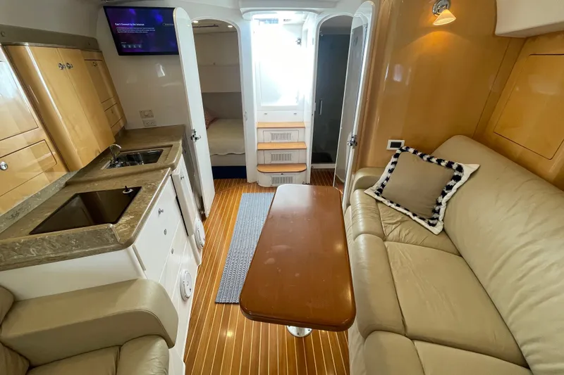 Slide: The Image of Interior of a 2009 Intrepid 430 Sport Yacht with cozy seating and kitchenette. - 47