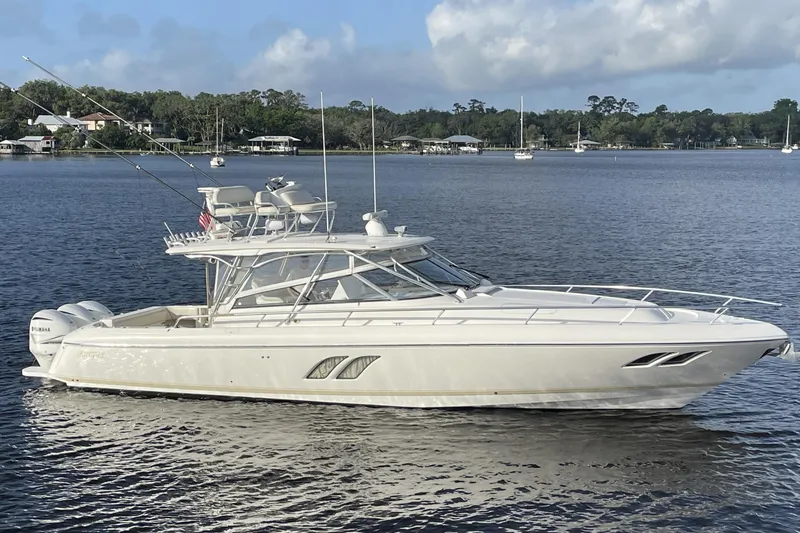Slide: The Image of 2009 Intrepid 430 Sport Yacht on calm water, showcasing sleek design and powerful engines. - 5