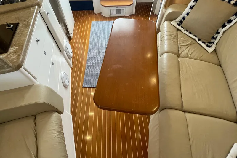 Slide: The Image of Interior of 2009 Intrepid 430 Sport Yacht with wooden table and beige seating. - 50