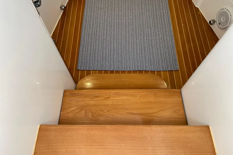 Slide: The Image of Wooden steps and carpeted floor inside a 2009 Intrepid 430 Sport Yacht. - 51