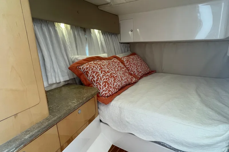 Slide: The Image of Cozy cabin interior of 2009 Intrepid 430 Sport Yacht with decorative pillows and curtains. - 52