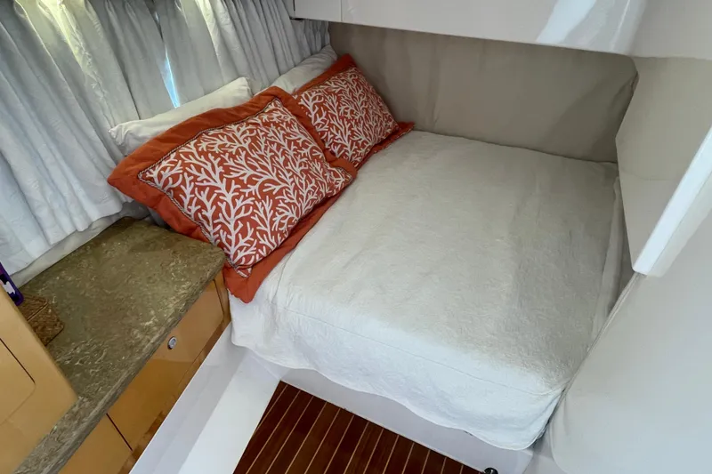 Slide: The Image of Cozy cabin interior of 2009 Intrepid 430 Sport Yacht with decorative pillows and wooden accents. - 53