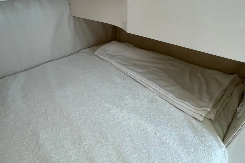 Slide: The Image of Interior cabin bed of 2009 Intrepid 430 Sport Yacht with folded blanket. - 54