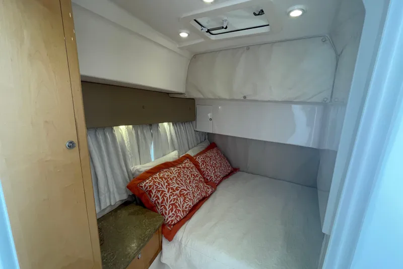 Slide: The Image of Cozy cabin interior of 2009 Intrepid 430 Sport Yacht with bed and decorative pillows. - 56