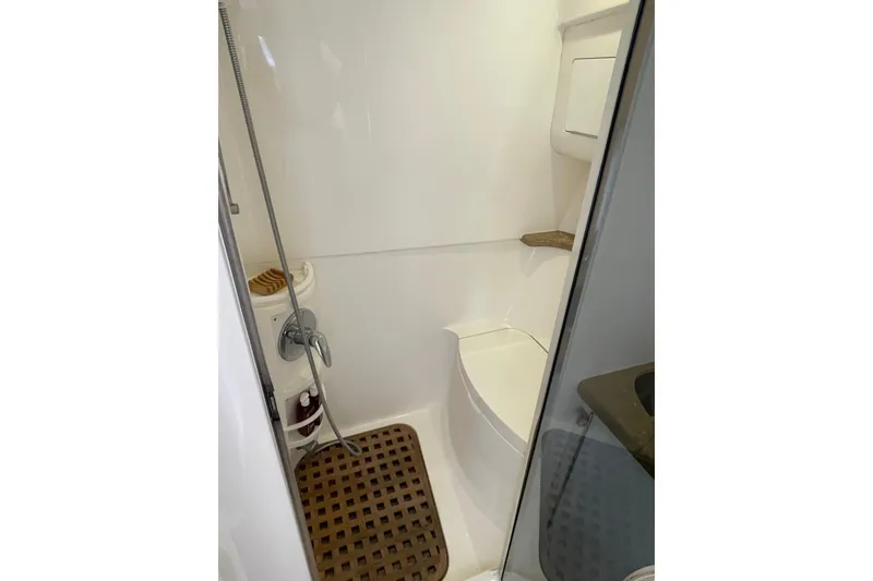 Slide: The Image of Compact bathroom in 2009 Intrepid 430 Sport Yacht with shower and wooden floor mat. - 59