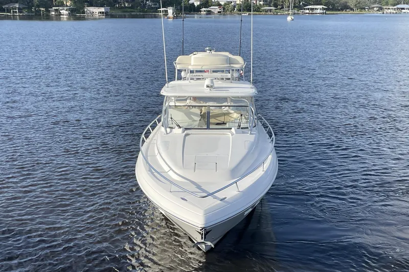 Slide: The Image of 2009 Intrepid 430 Sport Yacht on calm water, front view. - 6