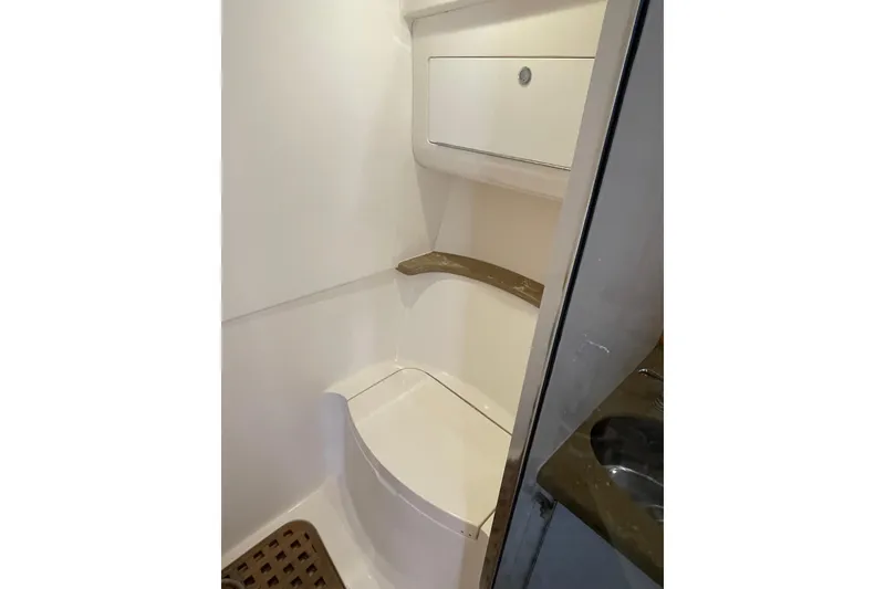 Slide: The Image of Bathroom interior of 2009 Intrepid 430 Sport Yacht, featuring compact design and storage. - 60