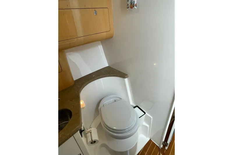 Slide: The Image of 2009 Intrepid 430 Sport Yacht bathroom with modern fixtures and wooden cabinetry. - 61