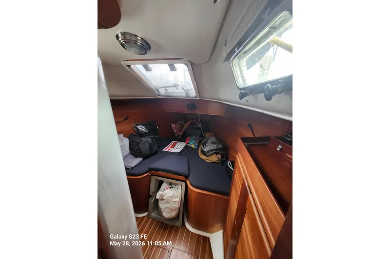 Slide: The Image of Interior of a 1995 Freedom 35 sailboat cabin with wooden finishes and storage. - 10
