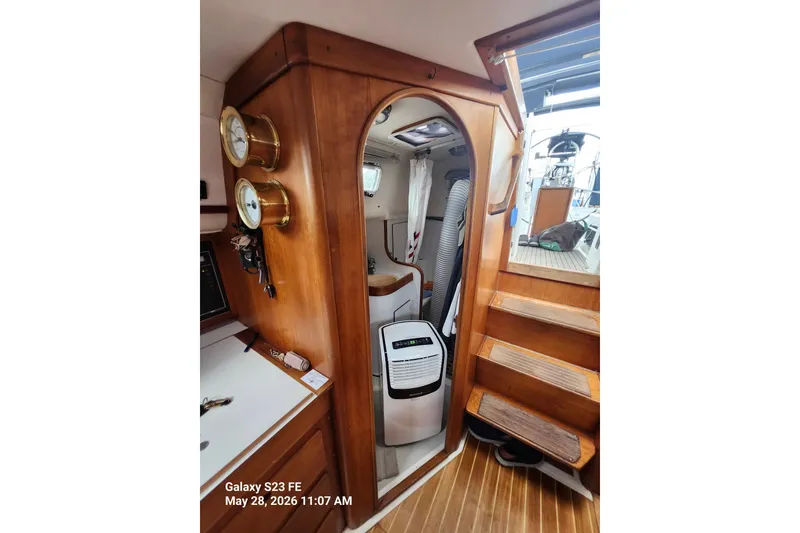 Slide: The Image of Interior of a 1995 Freedom 35 sailboat with wooden finish and nautical instruments. - 11