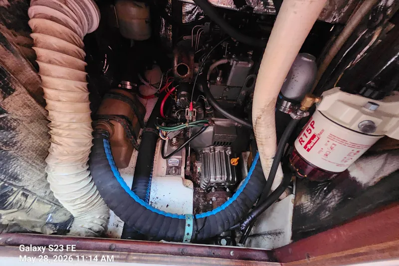 Slide: The Image of Engine compartment of a 1995 Freedom 35 boat, featuring hoses and a fuel filter. - 17