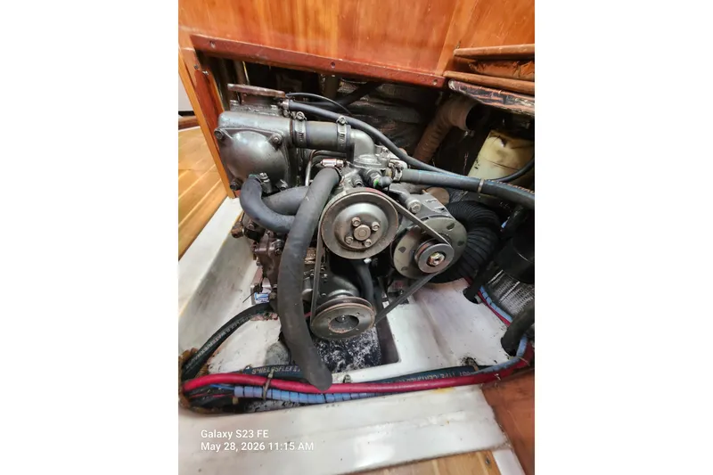 Slide: The Image of Engine compartment of a 1995 Freedom 35 sailboat, showcasing mechanical components and belts. - 19