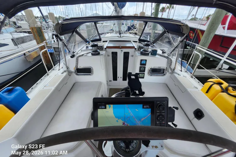 Slide: The Image of Cockpit view of a 1995 Freedom 35 sailboat with navigation equipment and marina background. - 2