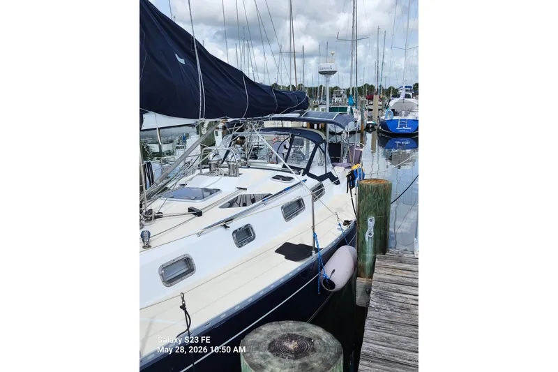 Slide: The Image of Sailboat Freedom 35, 1995 model, docked at marina with clear skies. - 27
