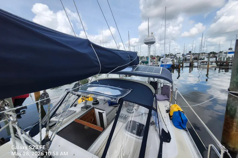 Slide: The Image of Sailboat Freedom 35, 1995 model, docked at marina with clear skies and calm waters. - 29