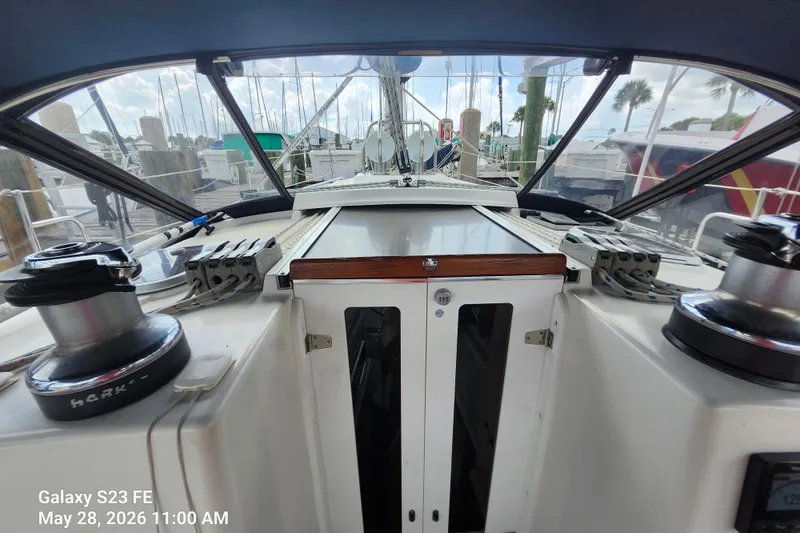 Slide: The Image of Cockpit view of a 1995 Freedom 35 sailboat docked at a marina. - 32
