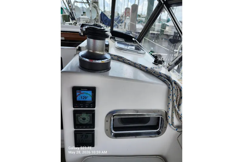 Slide: The Image of Sailboat cockpit with navigation instruments, winch, and ropes on a 1995 Freedom 35. - 33