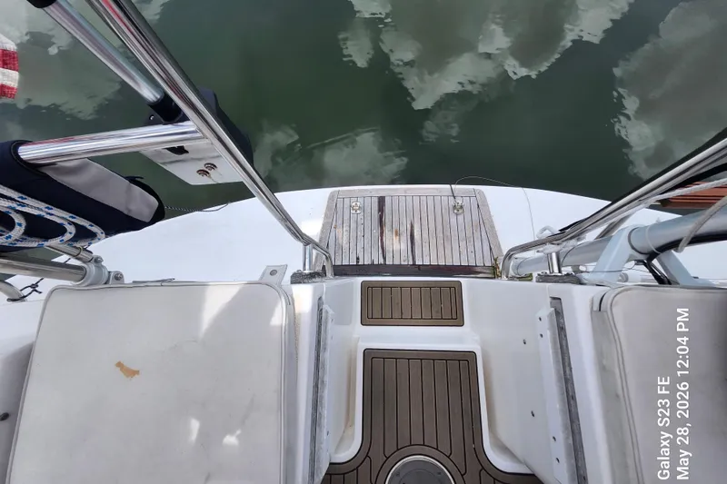 Slide: The Image of Stern view of a 1995 Freedom 35 sailboat with wooden deck and metal railings. - 37