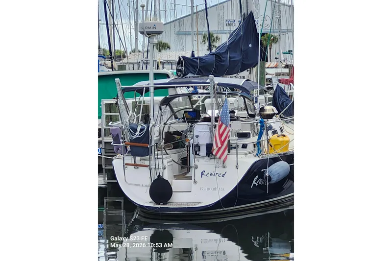 Slide: The Image of Sailboat "Rewired" docked, Freedom 35 model, 1995, with American flag, Falmouth, MA. - 38