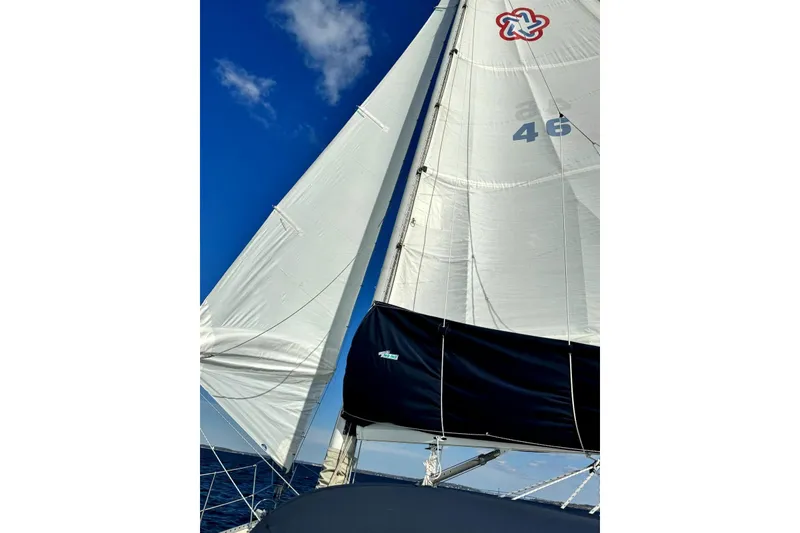 Slide: The Image of Sailing yacht Freedom 35, 1995 model, with white sails against a clear blue sky. - 39