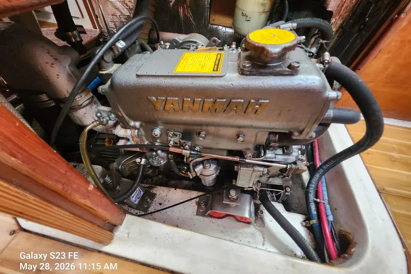 Slide: The Image of Yanmar engine in a 1995 Freedom 35 sailboat, detailed view with hoses and components. - 7