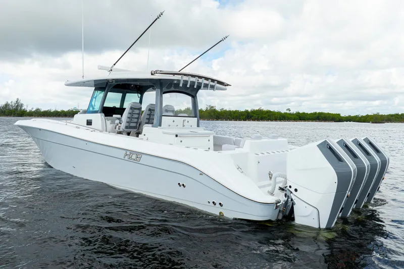 The Image of 2026 HCB 42 Lujo boat with multiple engines on a calm waterway. - 0