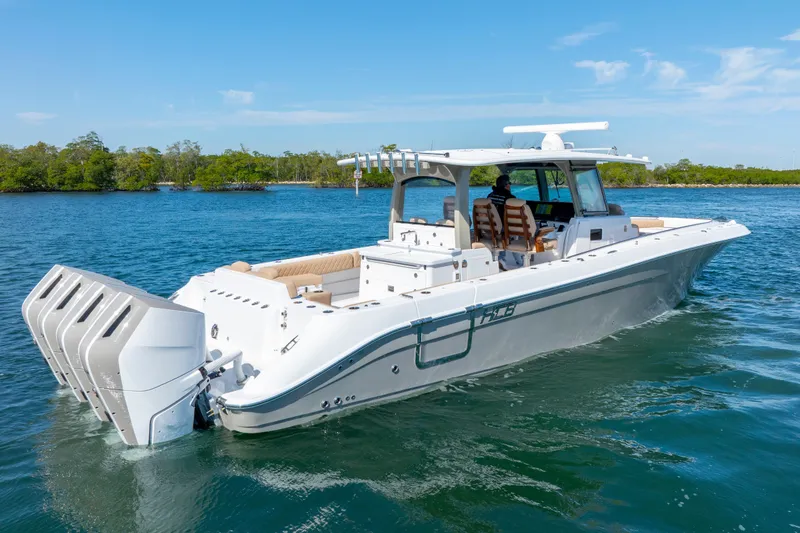 The Image of 2027 HCB 42 Lujo boat cruising on a sunny day with multiple outboard engines. - 1
