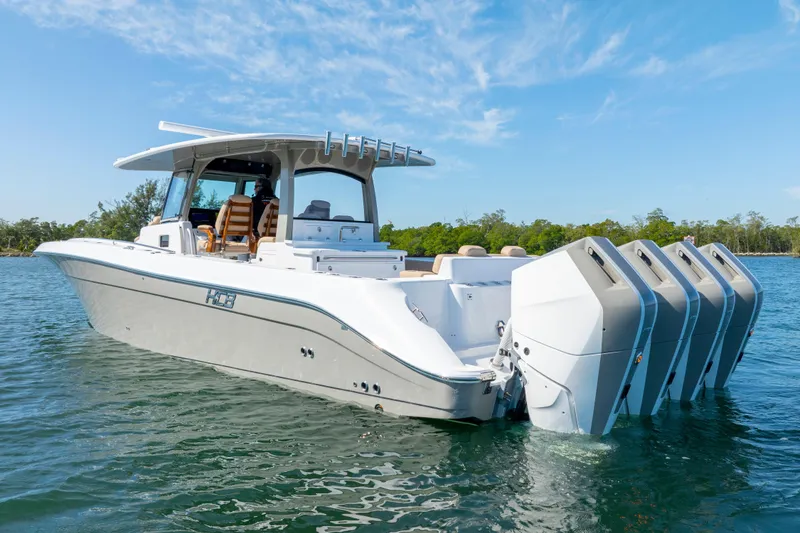 Slide: The Image of 2027 HCB 42 Lujo boat with four engines on a sunny day. - 12
