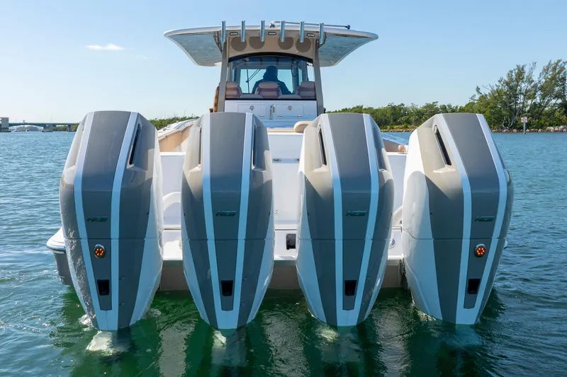 Slide: The Image of 2027 HCB 42 Lujo boat with four powerful outboard engines on water. - 13