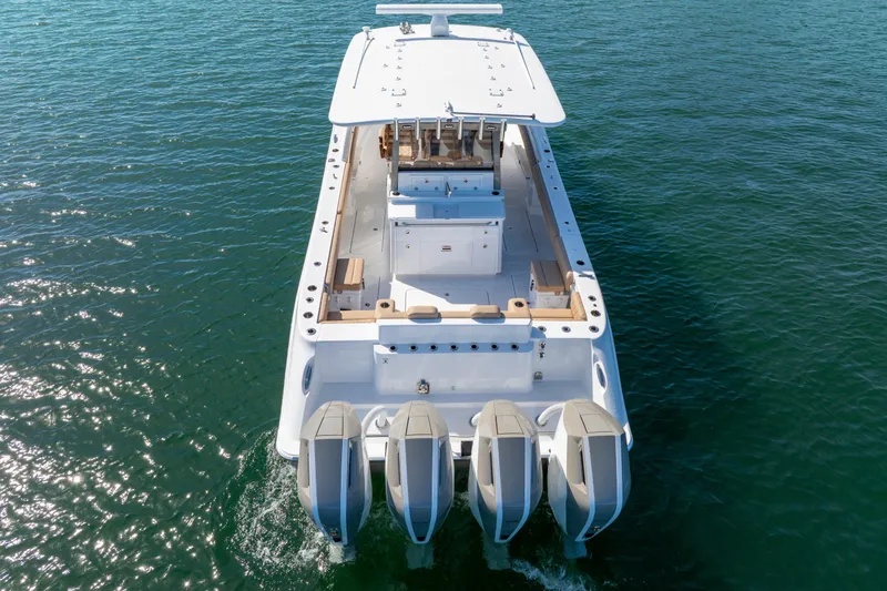 Slide: The Image of 2027 HCB 42 Lujo boat with four engines on open water, aerial rear view. - 14