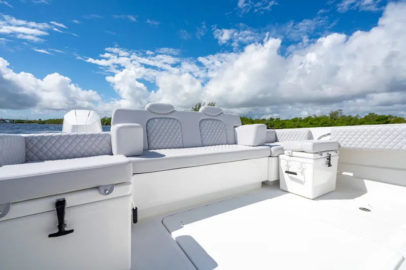 Slide: The Image of Luxurious seating on the 2026 HCB 42 Lujo boat under a bright blue sky. - 15